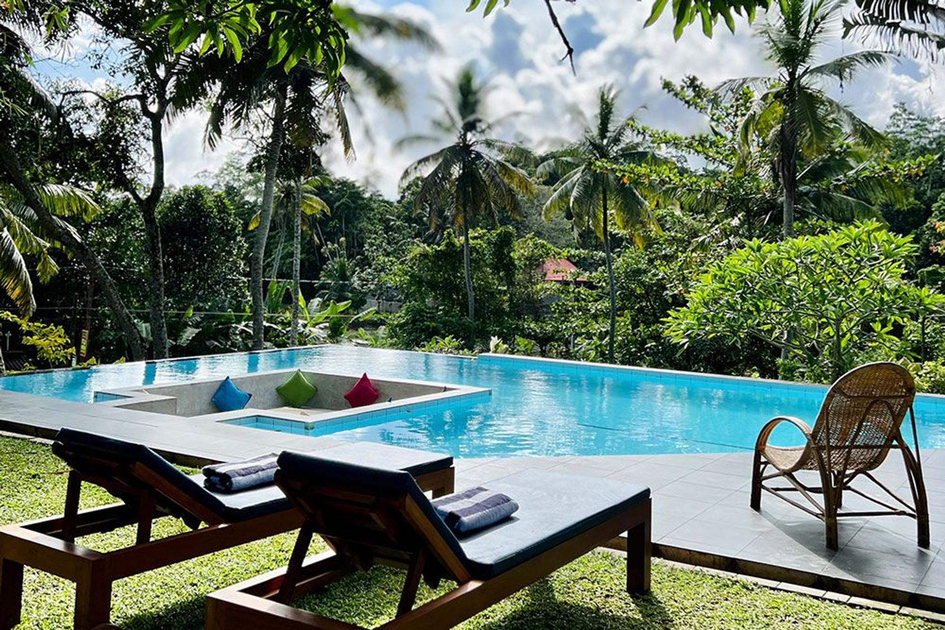 Serene pool area with sunbeds at Muthu Nila Villas